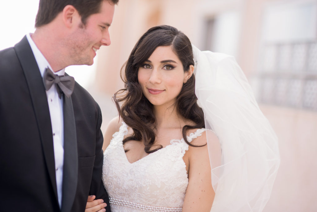 gorgeous bride with medium length hairstyle, veil, and lace gown
