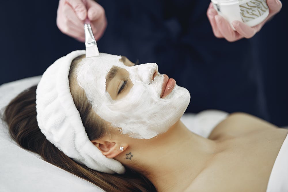 woman being given facial from an aesthetician