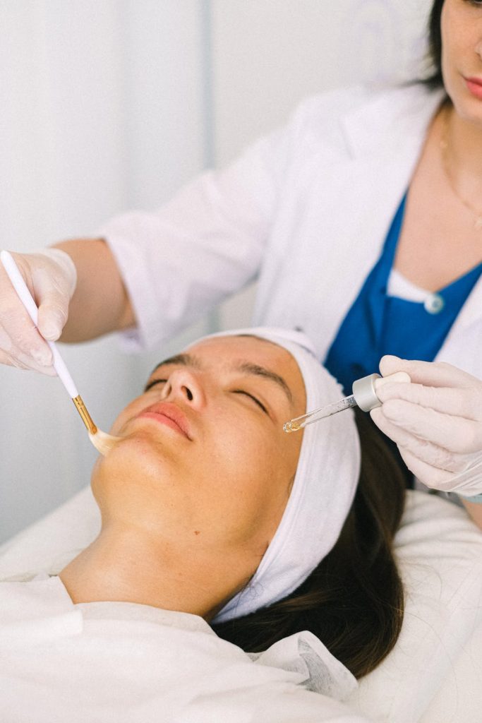 photo of woman getting a facial from an aesthetician 