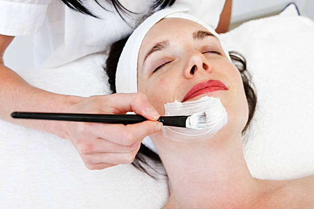 photo of woman having a facial with an aesthetician